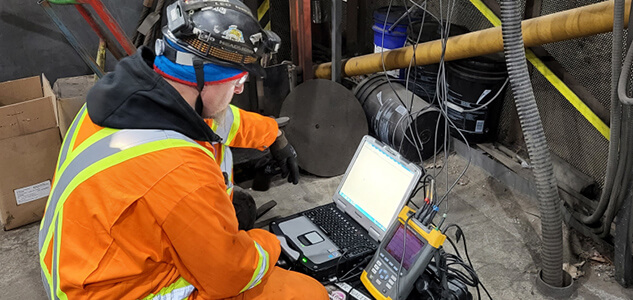 Workers testing machinery